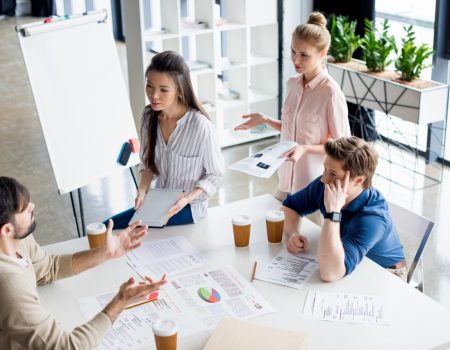 high-angle-view-of-group-of-young-business-people-discussing-new-project-on-small-business-meeting.jpg